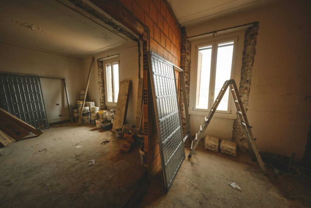 pexels-photo-15798783-15798783 Interior view of a room under renovation with construction materials and a ladder.